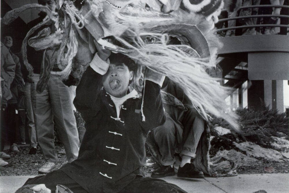 man holding up a traditional Chinese lion costume