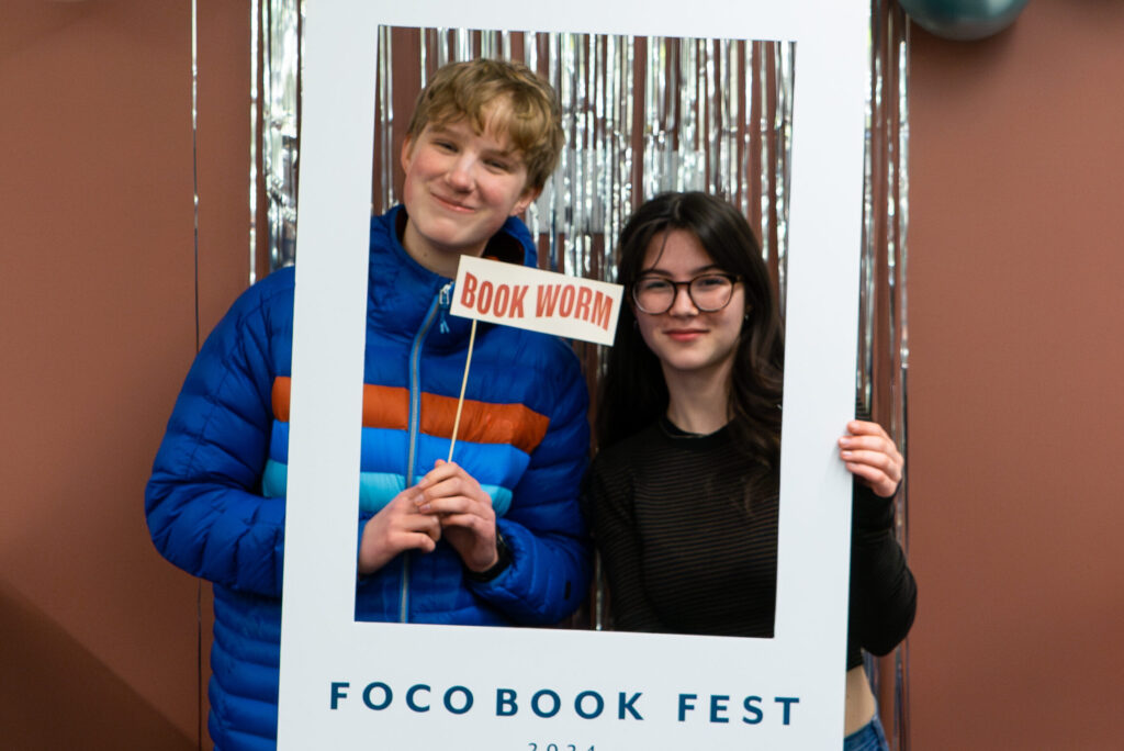 Two teens smile and pose for a photo
